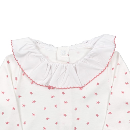 Pormenor de gola de tecido de babygrow de bebé branco cru com estrelas rosa.