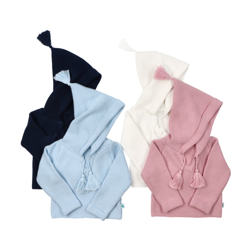 Quatro modelos da camisola de malha com carapuço para bebé e manga comprida. Aperta à frente, junto ao decote, com dois pompons de cada lado. O carapuço também termina com pompom.