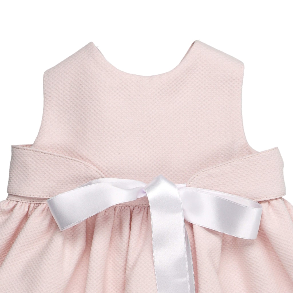Cueiro para bebé em tecido piquet rosa cum uma fita de cetim branco à frente que fecha em laço.