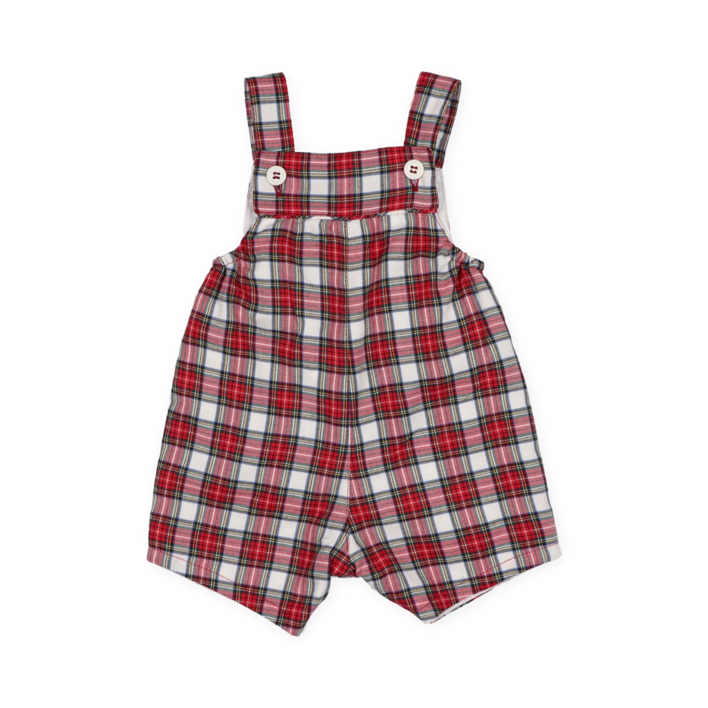 Jardineiras de bebé com perna curta feitas em tecido xadrez de algodão com tons de vermelho. Têm botões de madrepérola nas alças.
