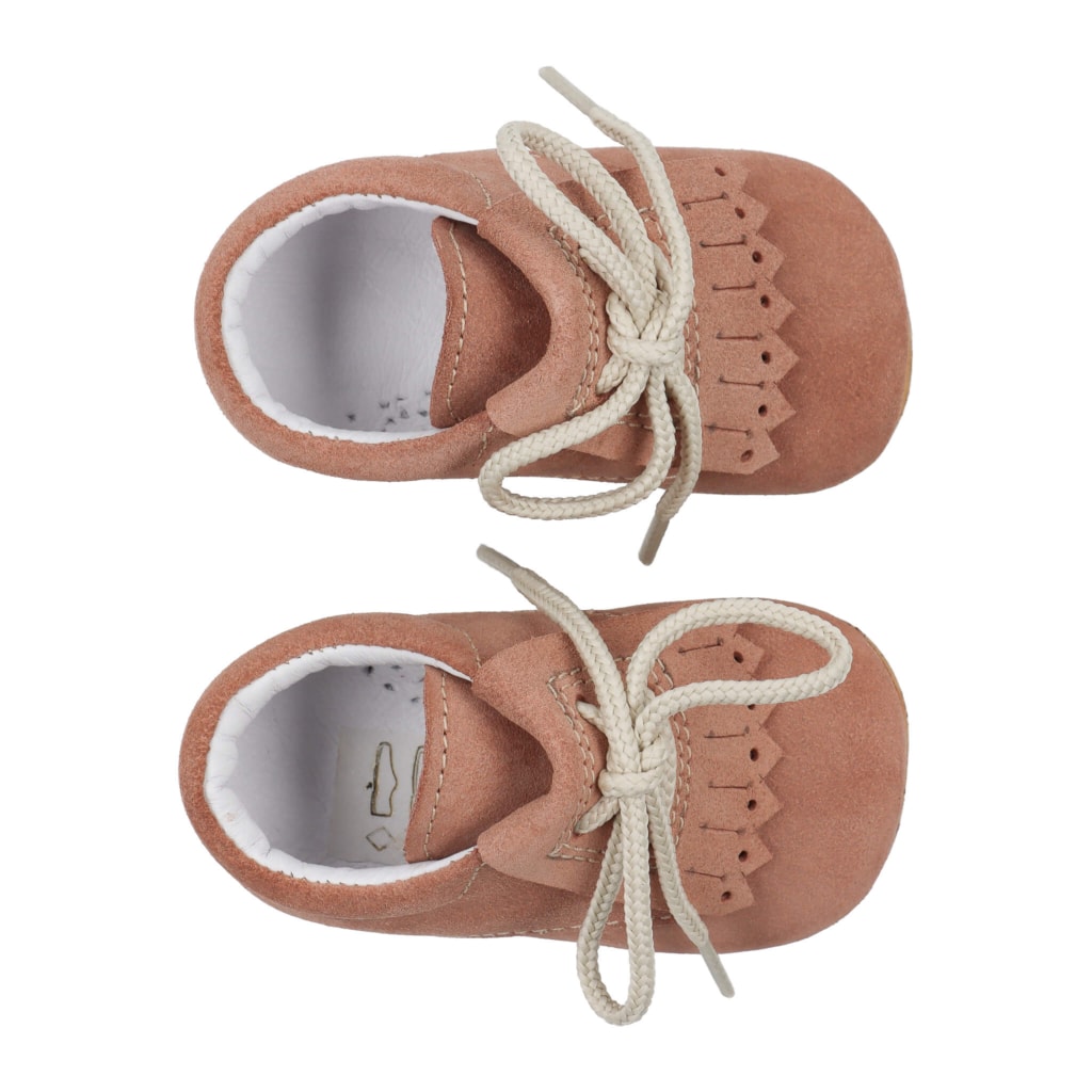 Sapatos para bebé tipo carneiras de cor camel. Têm uma pala na frente feita em pele da mesma cor do sapato.
